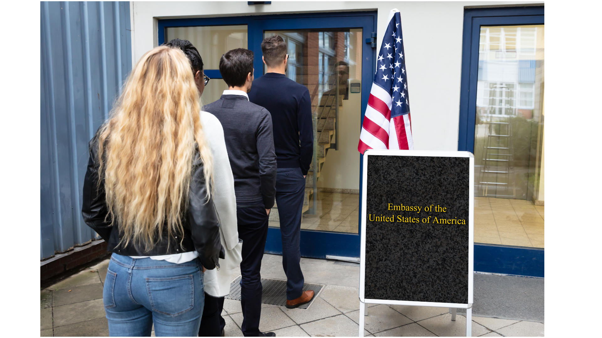 Students standing in line outside the U.S. Embassy, illustrating in-country visa interview requirements.
